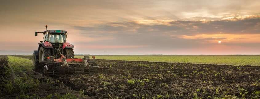 tractor plowing a farm field