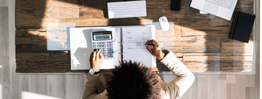 person working on financials at desk