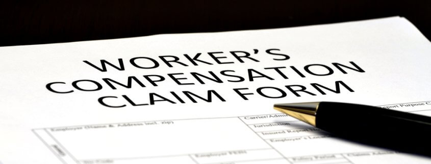 pen sitting on top of a workers' compensation claims form
