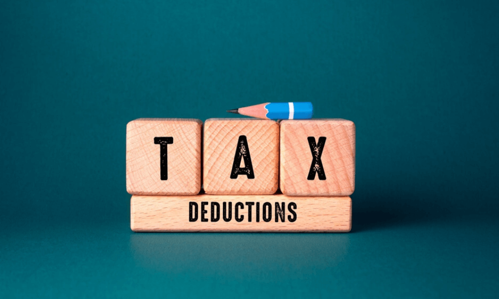 wooden blocks that read "tax deductions" on blue background