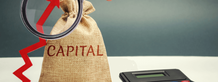 canvas bag reading "capital" next to an arrow pointing up and surrounded by coins