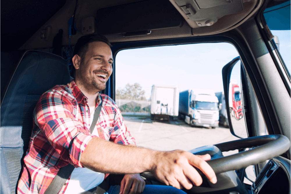 smiling trucker driving a semi truck