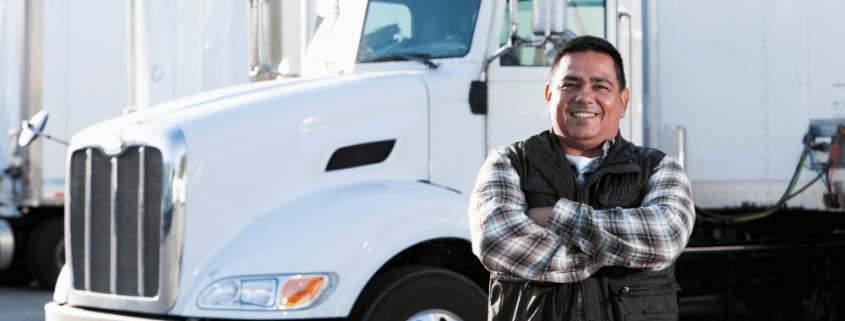 trucking business owner with his semi-truck behind him