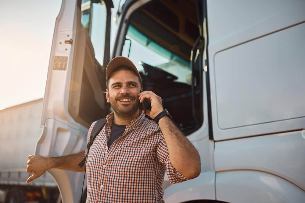 smiling trucker on cell phone