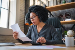 Business Owner Looking at Invoice During AR Dunning Process