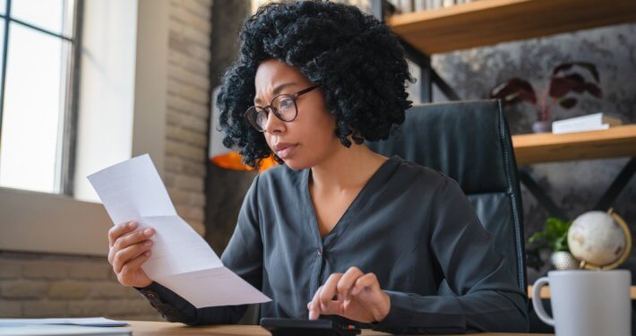 Business Owner Looking at Invoice During AR Dunning Process