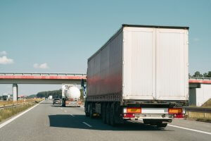 truck driving on highway coming to a stop