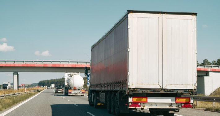 truck driving on highway coming to a stop